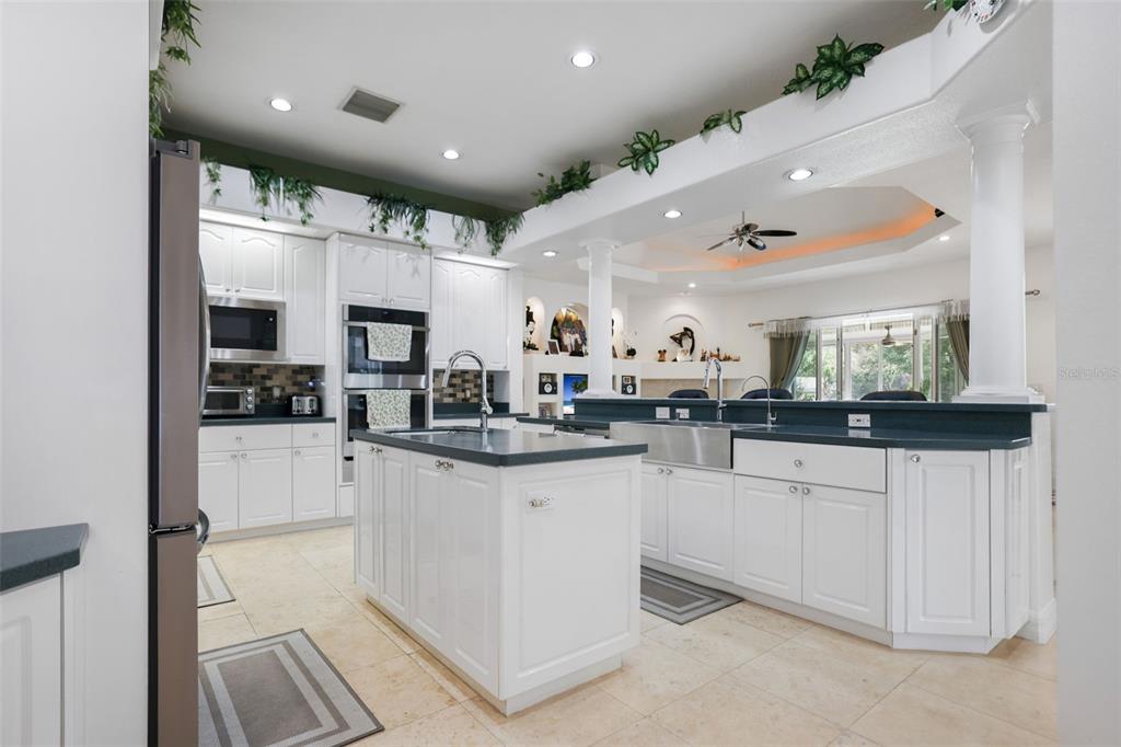14423 Kandi Court Largo, FL 33774 - Photo 12 of 75 a kitchen with stainless steel appliances kitchen island granite countertop a refrigerator and microwave