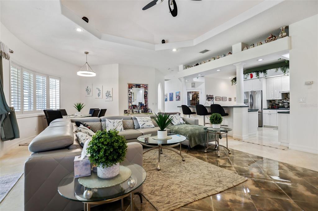 14423 Kandi Court Largo, FL 33774 - Photo 19 of 75 a living room with furniture kitchen view and a potted plant