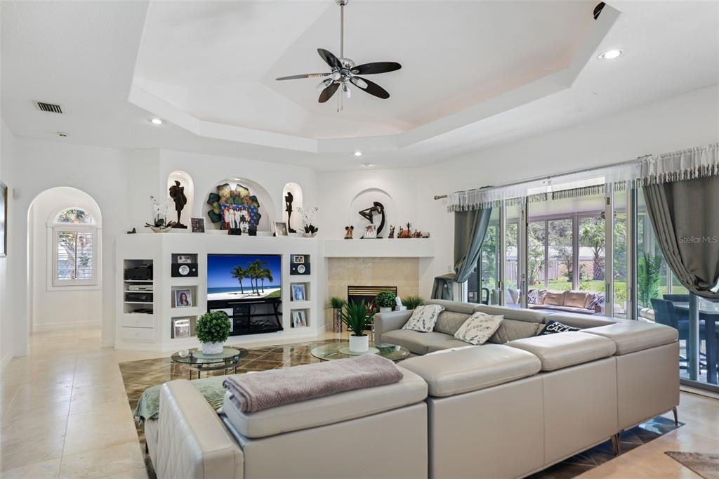 14423 Kandi Court Largo, FL 33774 - Photo 20 of 75 a living room with furniture a fireplace and a large window