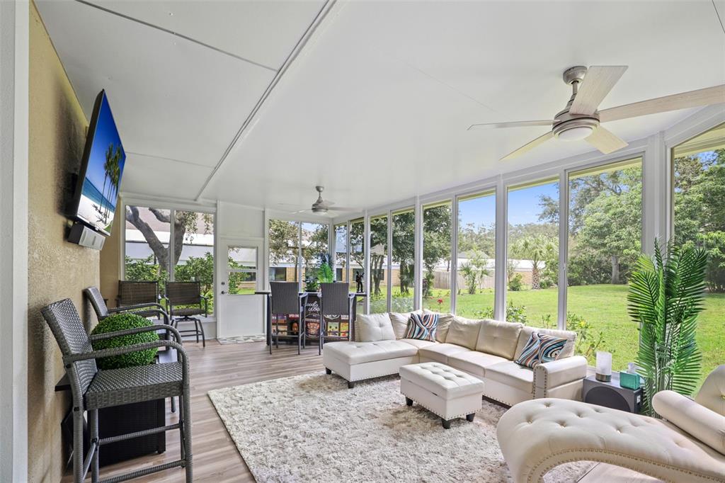 14423 Kandi Court Largo, FL 33774 - Photo 23 of 75 a living room with furniture and a floor to ceiling window
