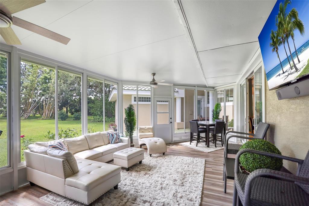 14423 Kandi Court Largo, FL 33774 - Photo 24 of 75 a living room with patio furniture and a floor to ceiling window