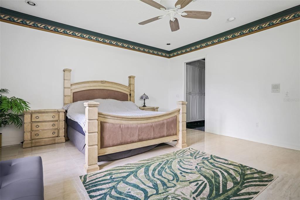 14423 Kandi Court Largo, FL 33774 - Photo 29 of 75 a bedroom with a bed and a chandelier