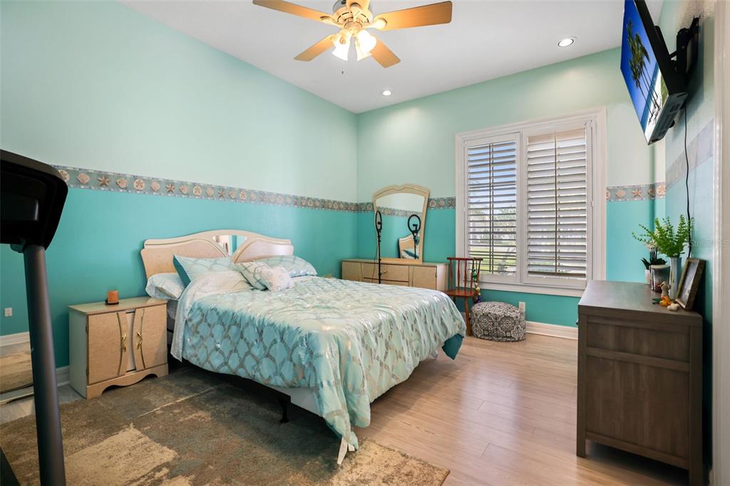 14423 Kandi Court Largo, FL 33774 - Photo 42 of 75 a bedroom with a bed and a chandelier