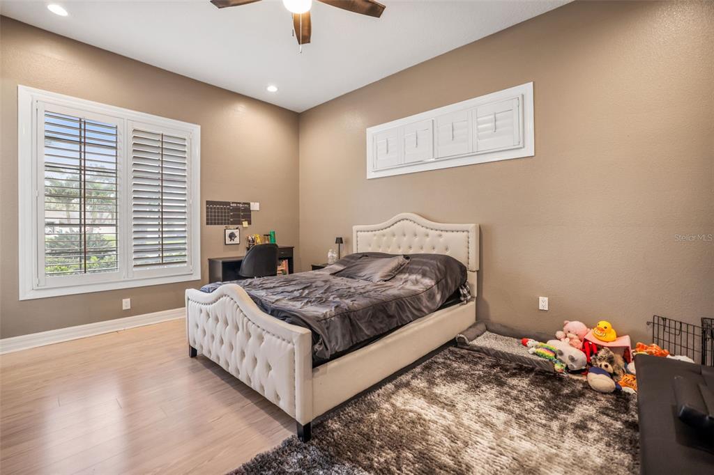 14423 Kandi Court Largo, FL 33774 - Photo 48 of 75 a bedroom with a bed chandelier and a window