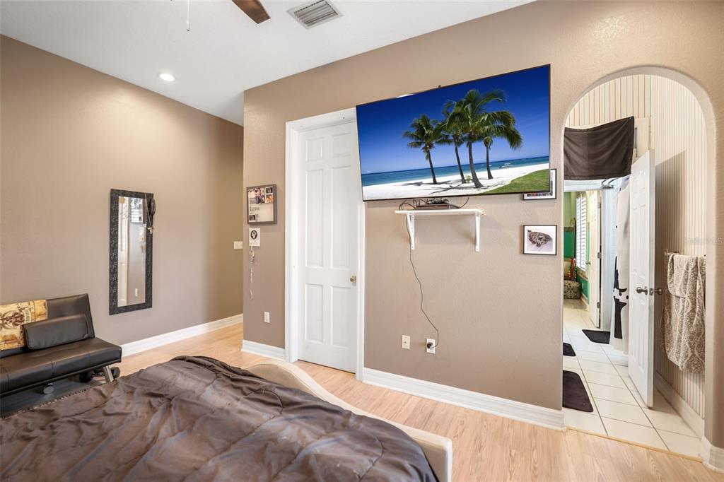 14423 Kandi Court Largo, FL 33774 - Photo 49 of 75 a bedroom with a bed and a painting on the wall
