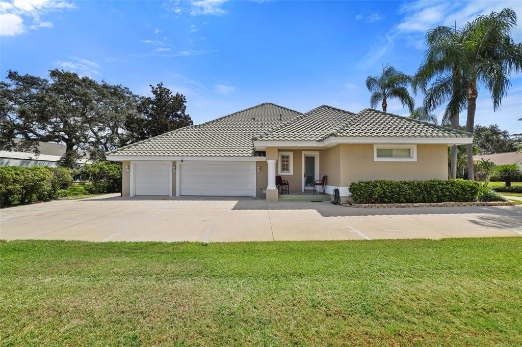 14423 Kandi Court Largo, FL 33774 - Photo 56 of 75 a front view of a house with a garden and yard