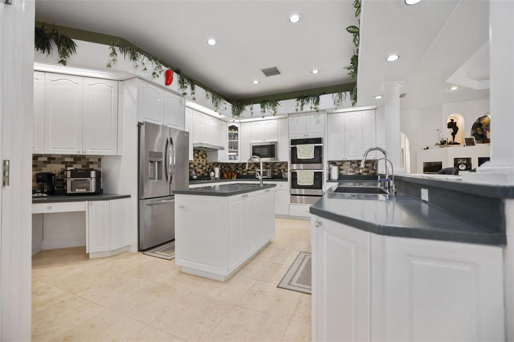 14423 Kandi Court Largo, FL 33774 - Photo 10 of 75 a kitchen with stainless steel appliances a refrigerator sink and microwave