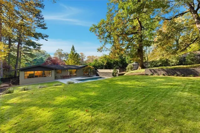 a front view of a house with a garden and yard