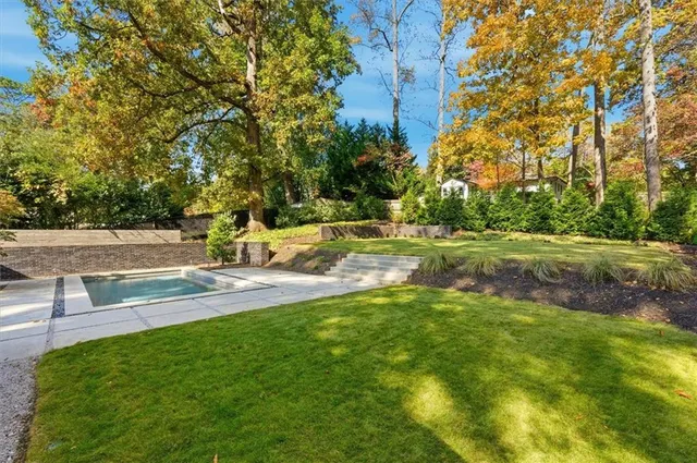 a brick house with trees in front of it