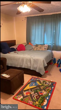 a bedroom with a bed and a lamp