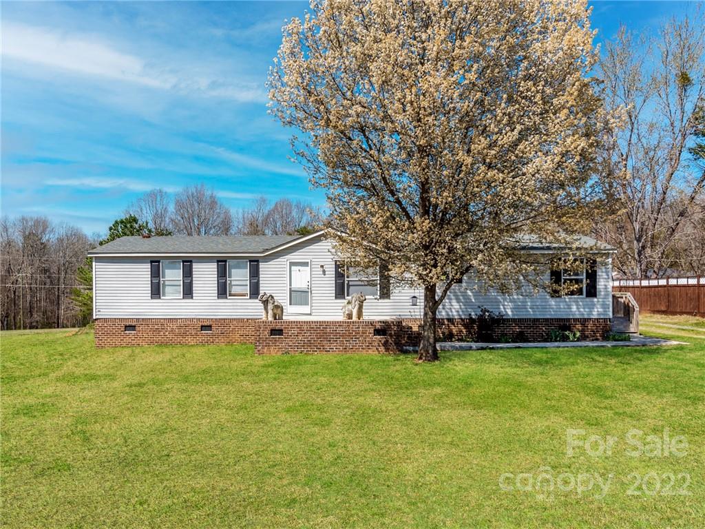 3402 Griffith Road Monroe, NC 28112 - Photo 1 of 28 a view of a house with a big yard and large trees
