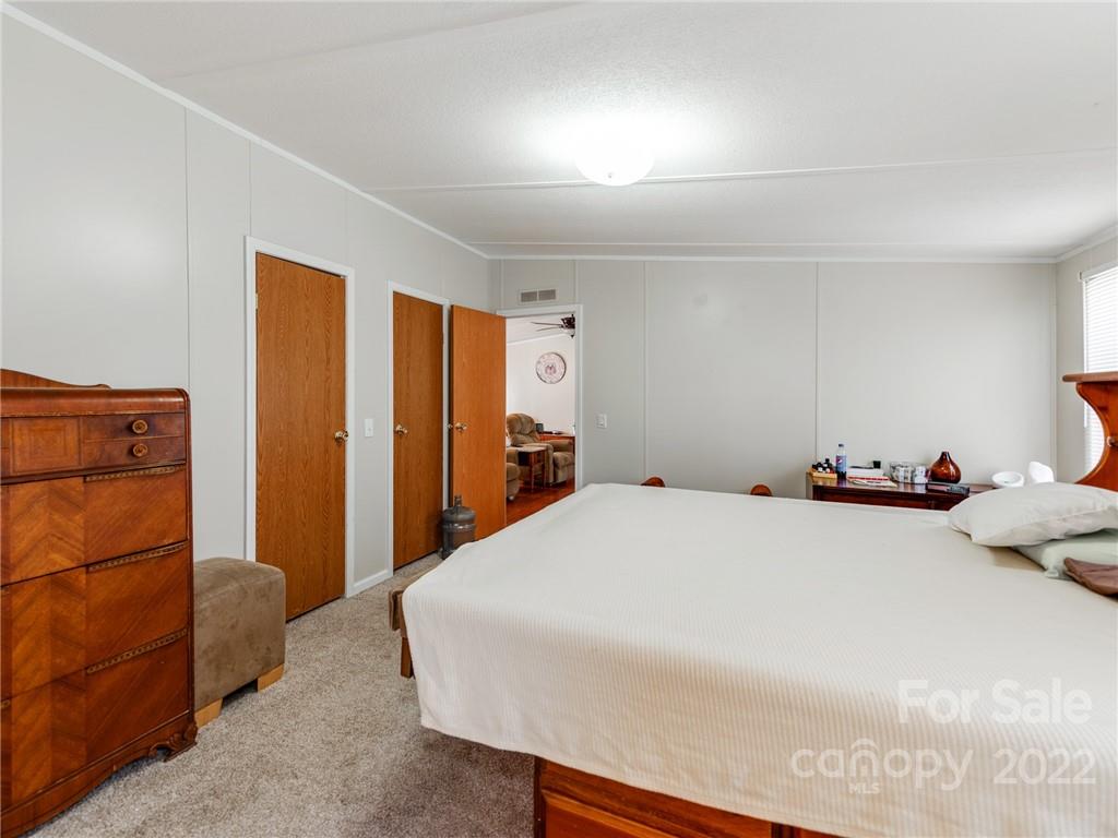 3402 Griffith Road Monroe, NC 28112 - Photo 13 of 28 a bedroom with a bed and a refrigerator