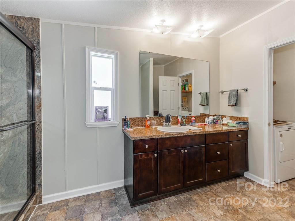 3402 Griffith Road Monroe, NC 28112 - Photo 14 of 28 a bathroom with a double vanity sink and mirror with shower