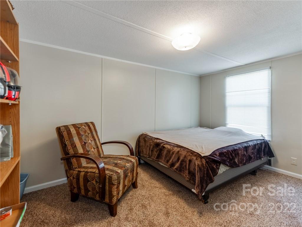 3402 Griffith Road Monroe, NC 28112 - Photo 21 of 28 a bedroom with bed chair and window