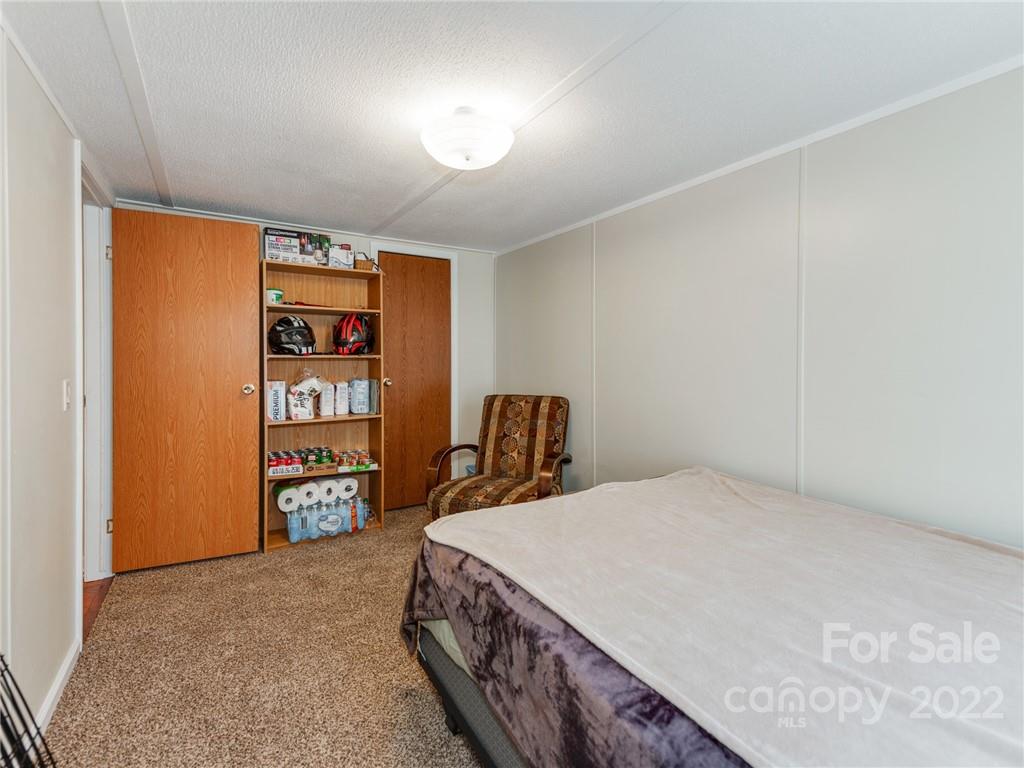 3402 Griffith Road Monroe, NC 28112 - Photo 22 of 28 a bed sitting in a bedroom next to a cabinet