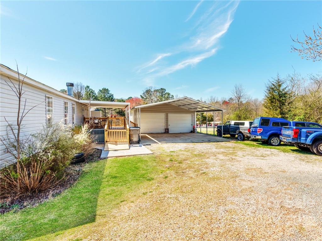 3402 Griffith Road Monroe, NC 28112 - Photo 25 of 28 a front view of a house with a yard and a car park