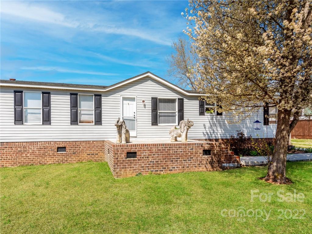 3402 Griffith Road Monroe, NC 28112 - Photo 3 of 28 a front view of a house with a garden