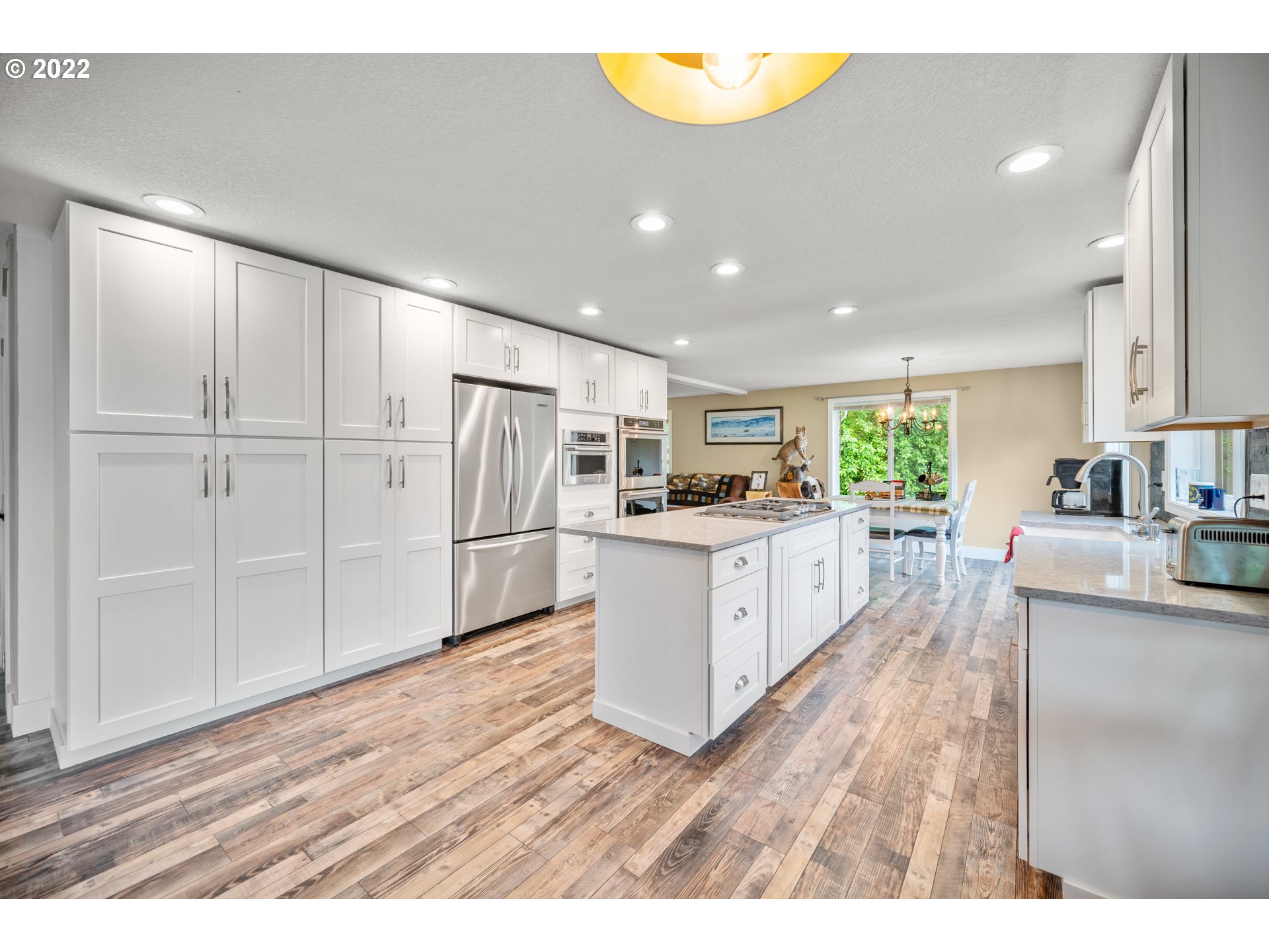 16207 Northeast Beebe Road Battle Ground, WA 98604 - Photo 11 of 32 a kitchen with stainless steel appliances a refrigerator and a wooden floor