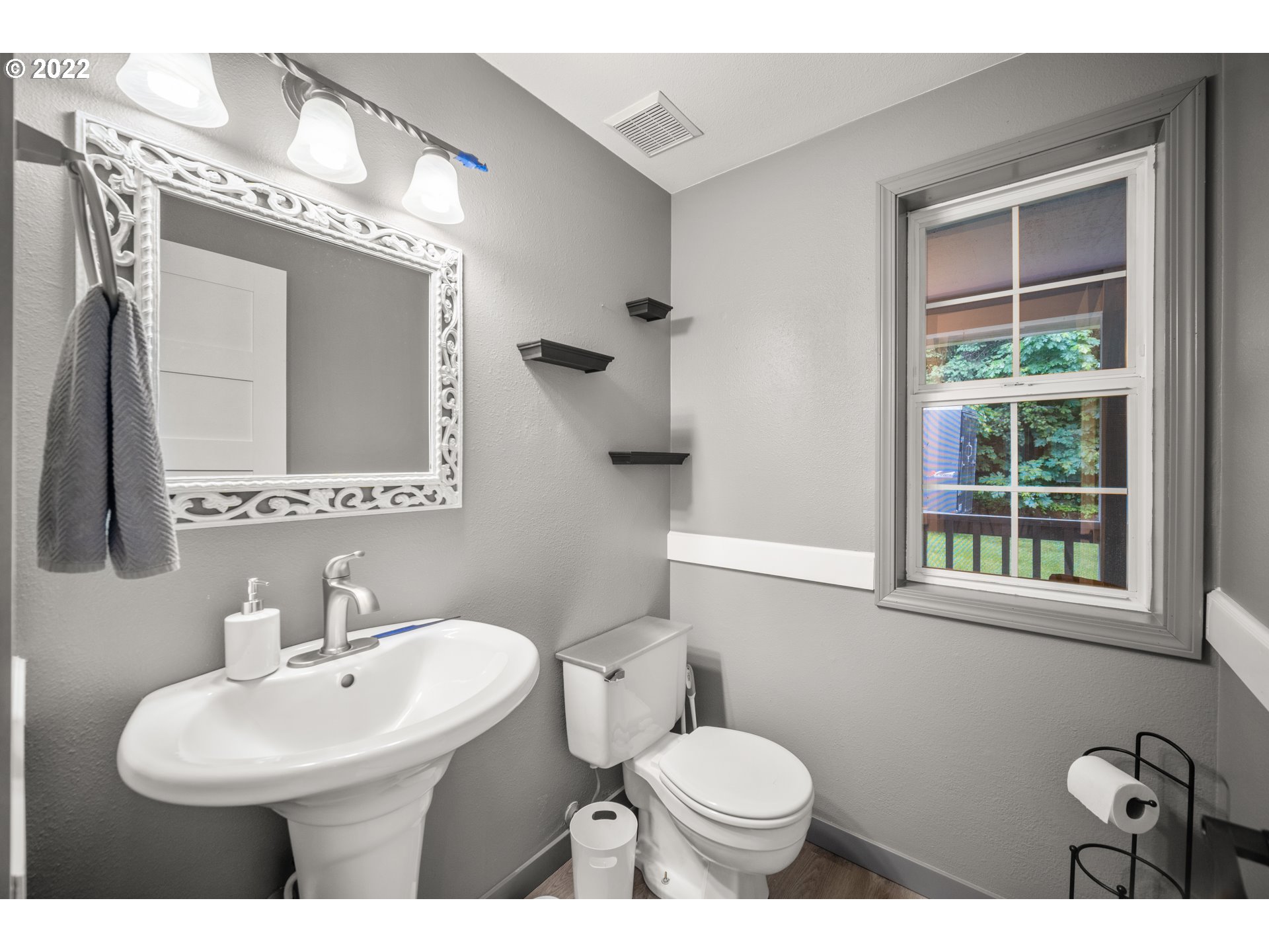 16207 Northeast Beebe Road Battle Ground, WA 98604 - Photo 13 of 32 a bathroom with a toilet a sink a mirror and a window
