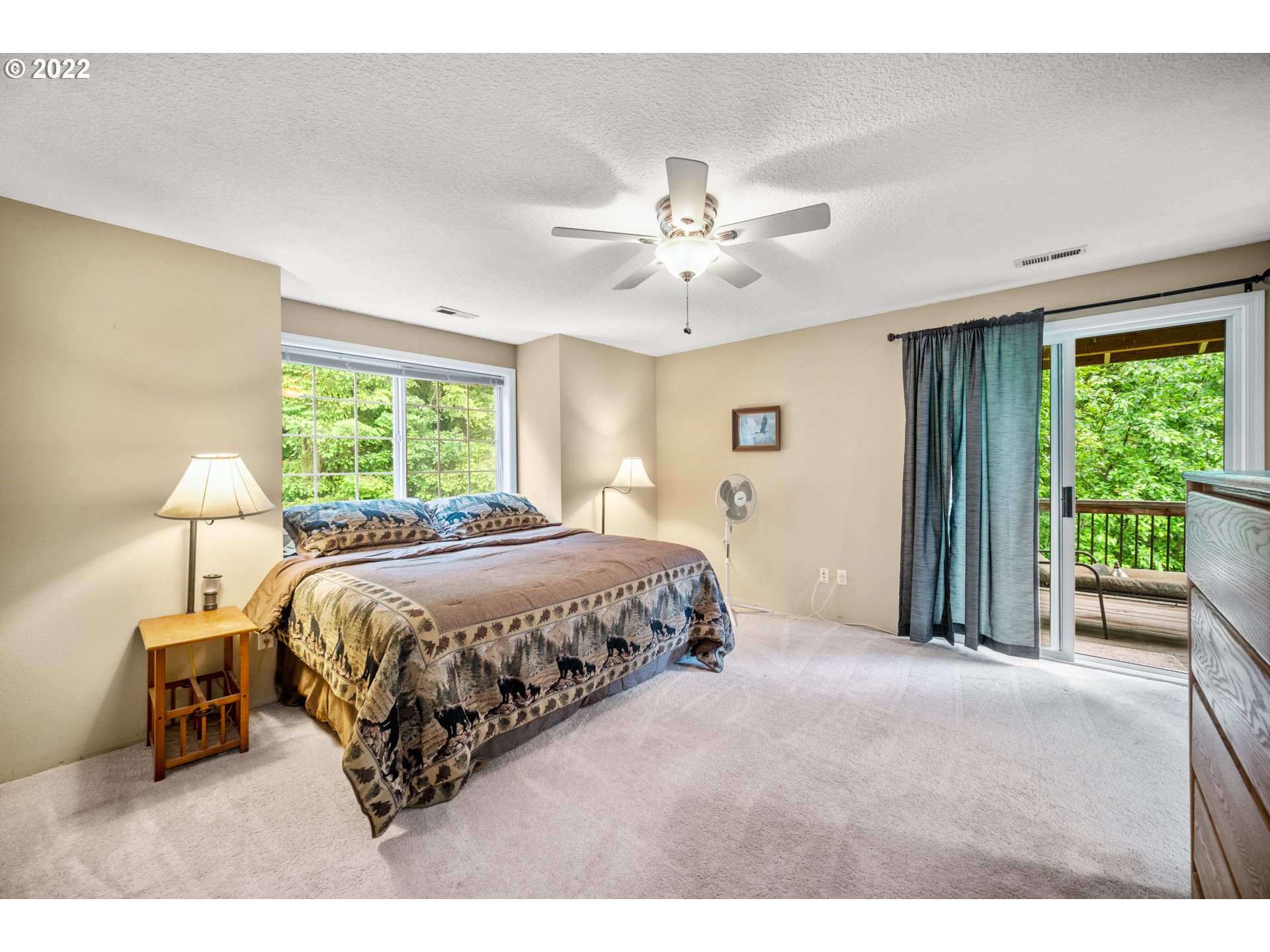 16207 Northeast Beebe Road Battle Ground, WA 98604 - Photo 21 of 32 a spacious bedroom with a bed and a lamp