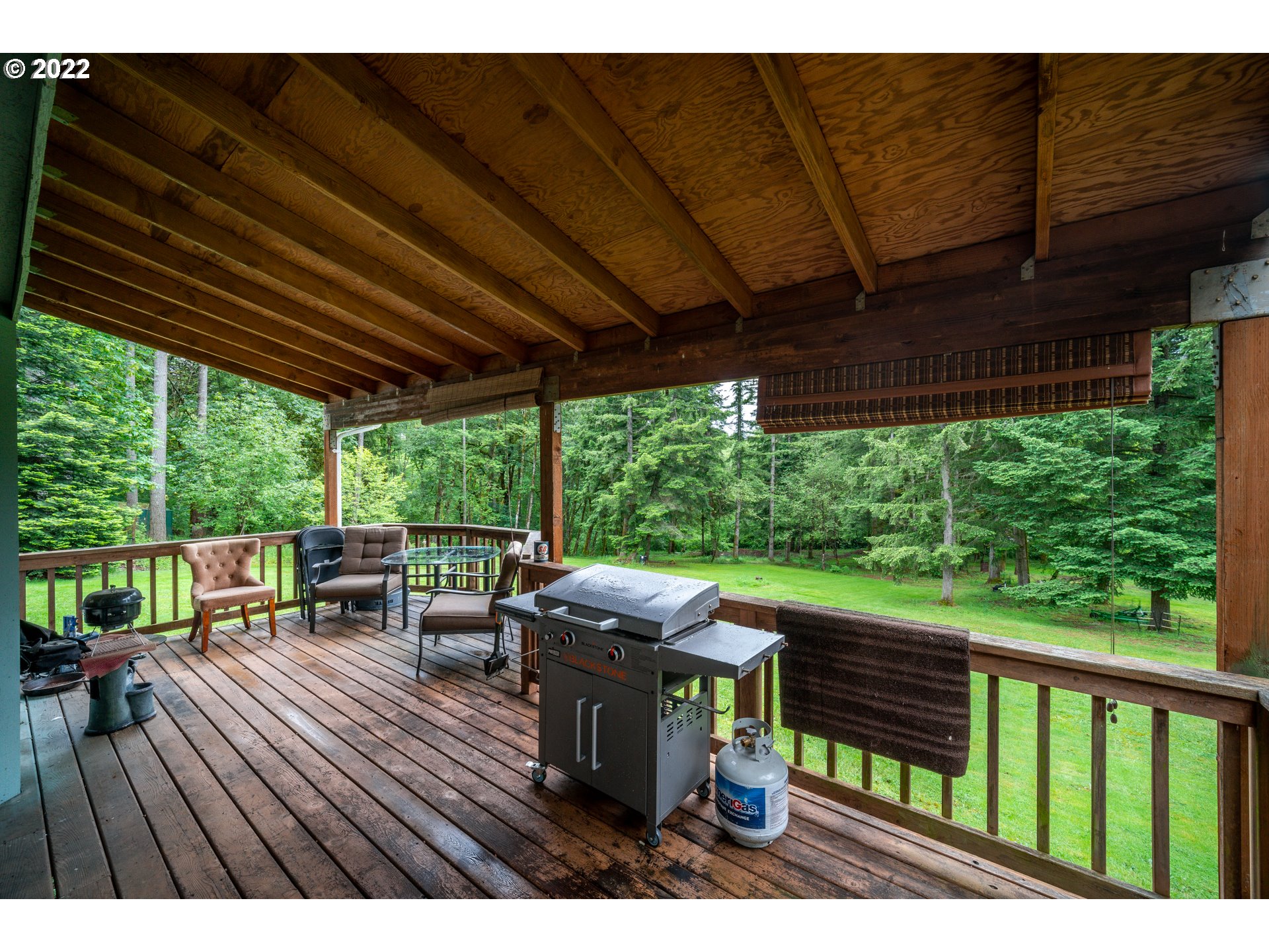 16207 Northeast Beebe Road Battle Ground, WA 98604 - Photo 26 of 32 a view of a patio with table and chairs potted plants with wooden floor and floor to ceiling window