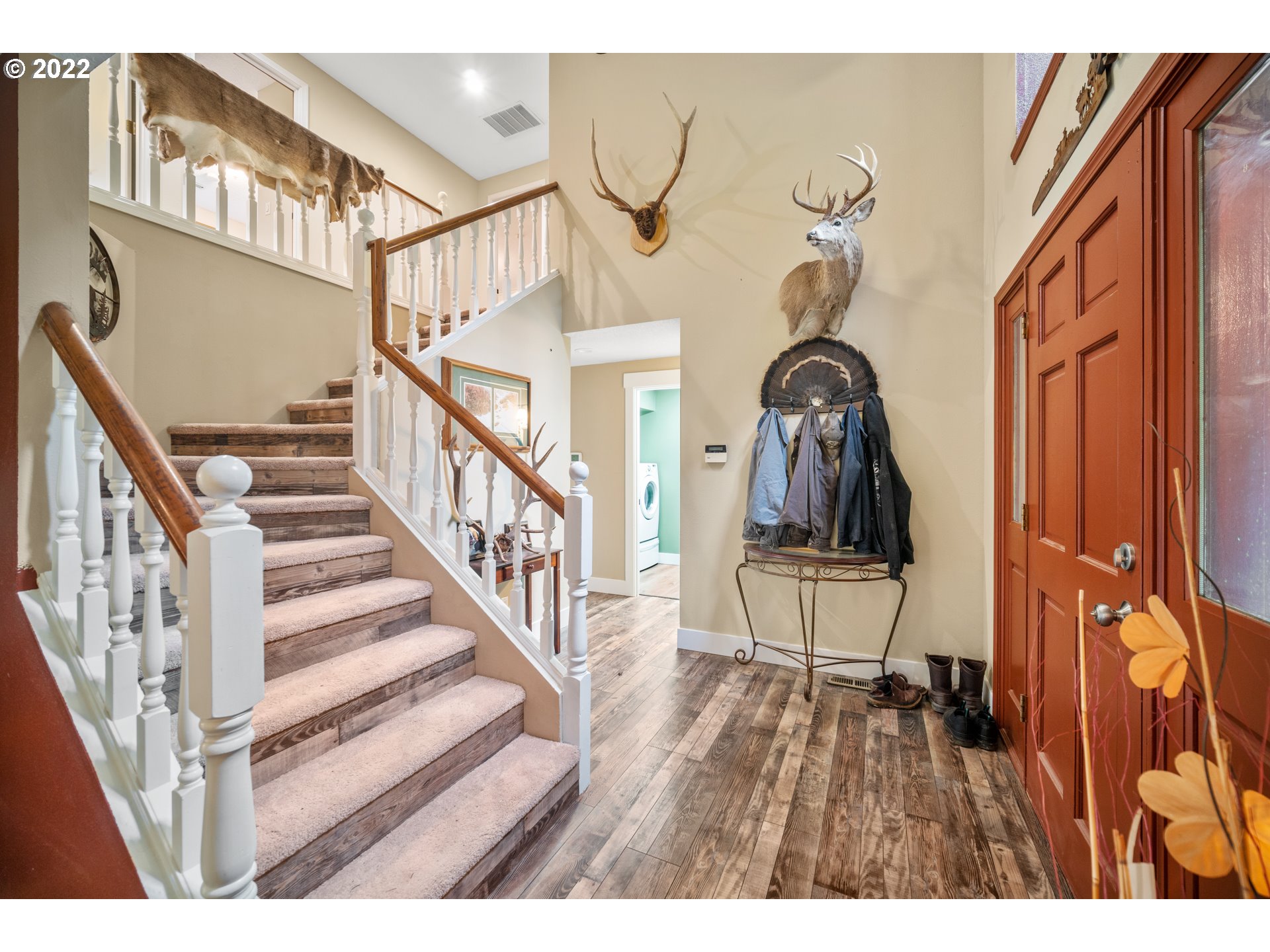 16207 Northeast Beebe Road Battle Ground, WA 98604 - Photo 5 of 32 a view of staircase with lots of frames on wall and wooden floor