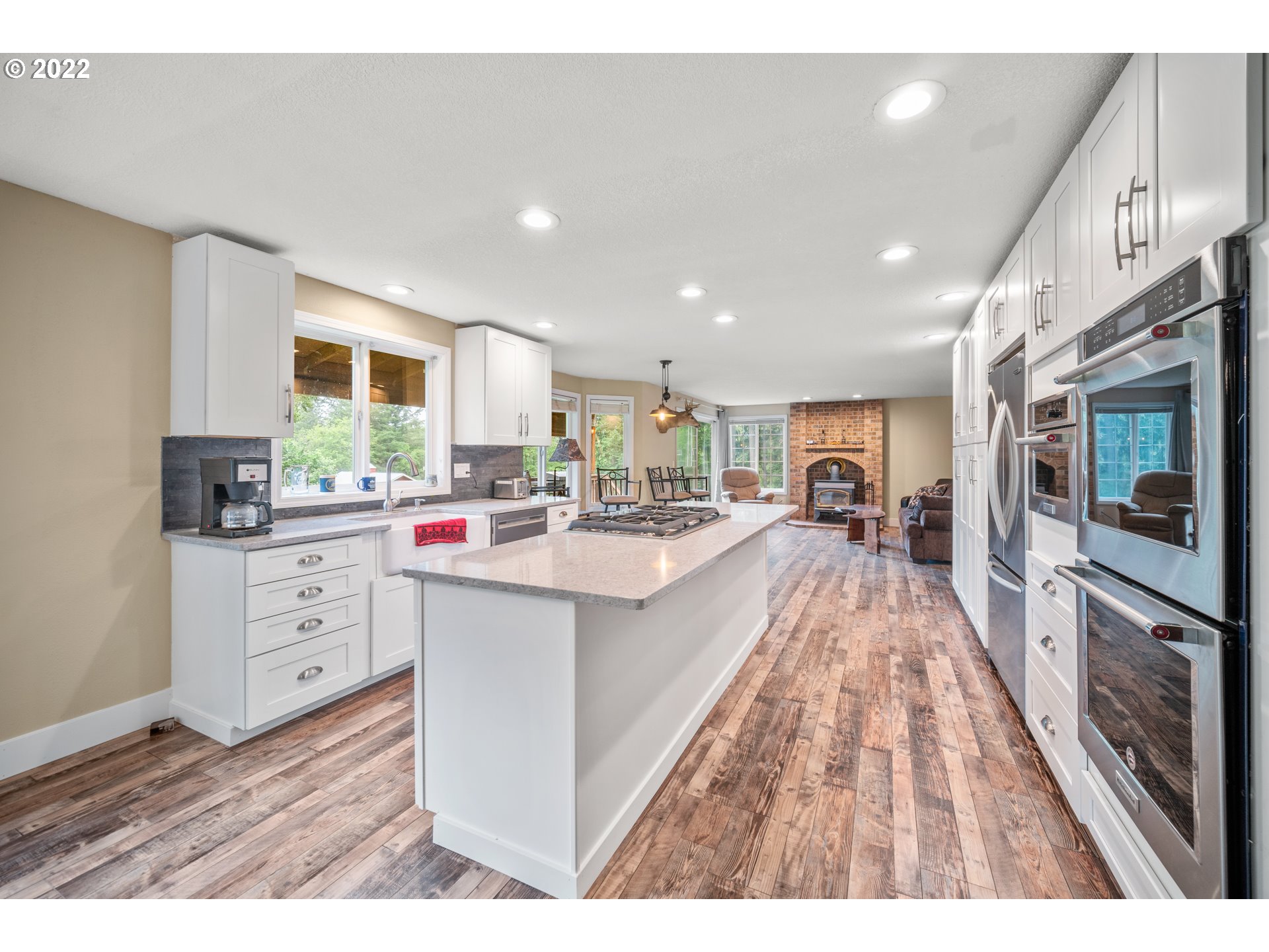 16207 Northeast Beebe Road Battle Ground, WA 98604 - Photo 9 of 32 a kitchen with white cabinets sink and black appliances