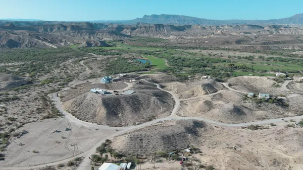 a view of a dry yard with green space