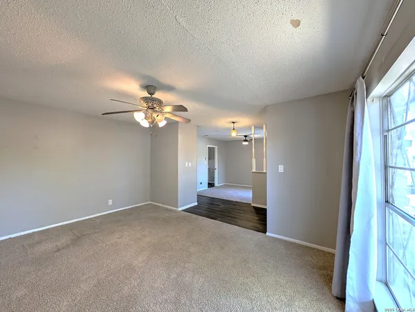 a view of a livingroom with a ceiling fan and window