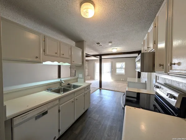 a kitchen with a sink and a stove top oven