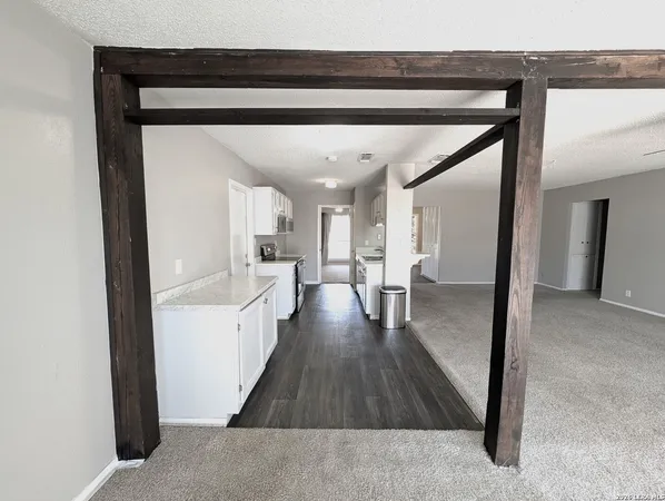 a view of a hallway view with wooden floor and furniture