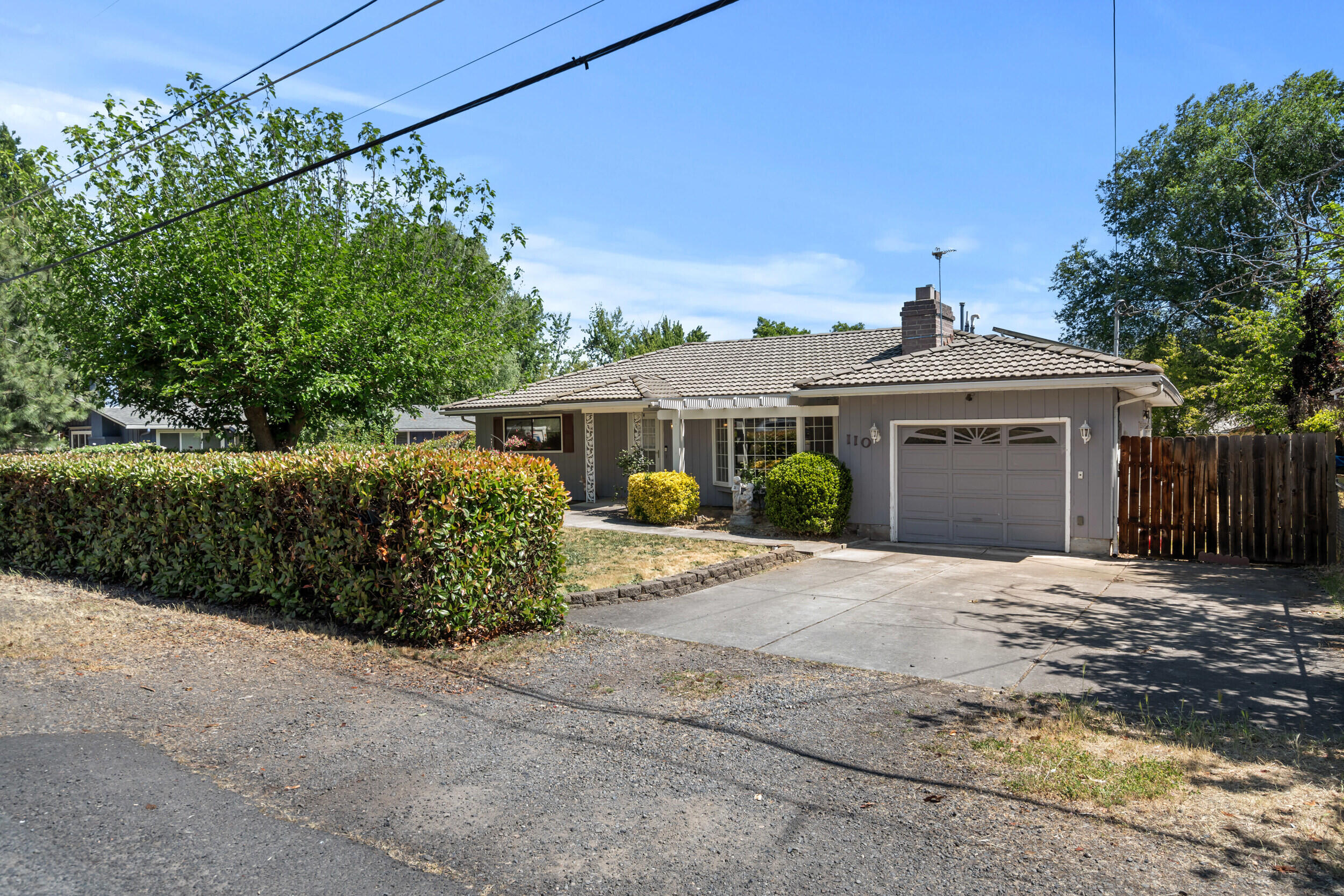 110 North 2nd Street Talent, OR 97540 - Photo 3 of 27 a front view of a house with a garden and yard