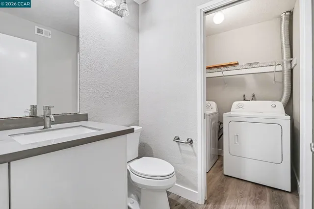 a bathroom with a sink toilet and vanity
