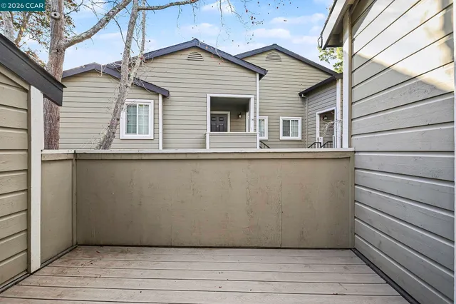 a view of a house with a wooden deck