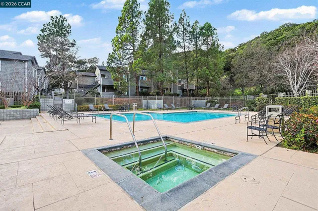 a view of a swimming pool with chairs