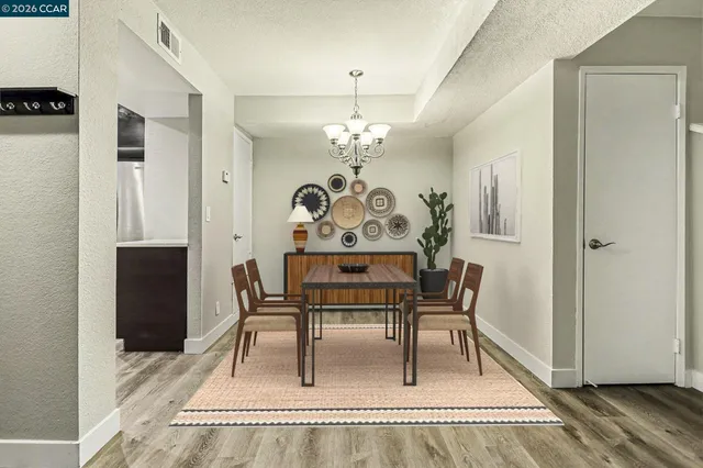 a dining room with furniture a rug and a chandelier