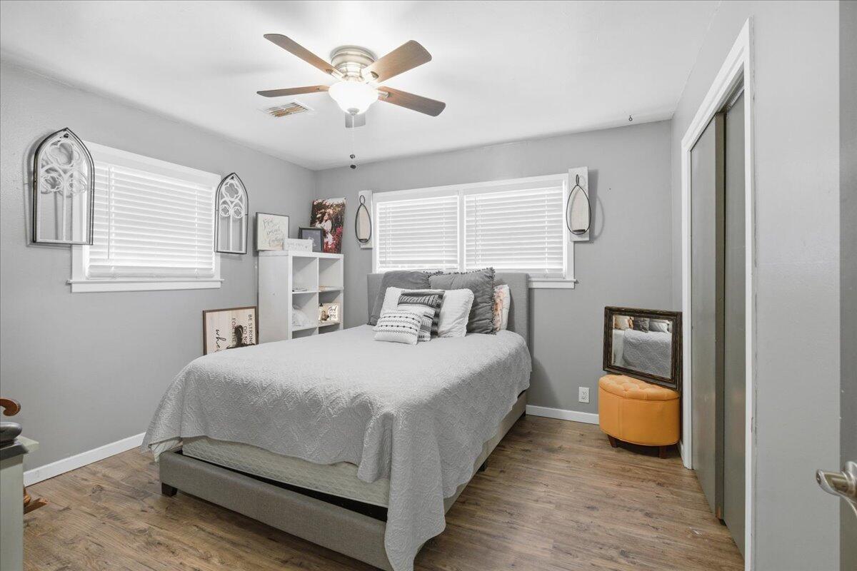 3816 44th Street Lubbock, TX 79413 - Photo 17 of 36 a bedroom with a bed and a chandelier