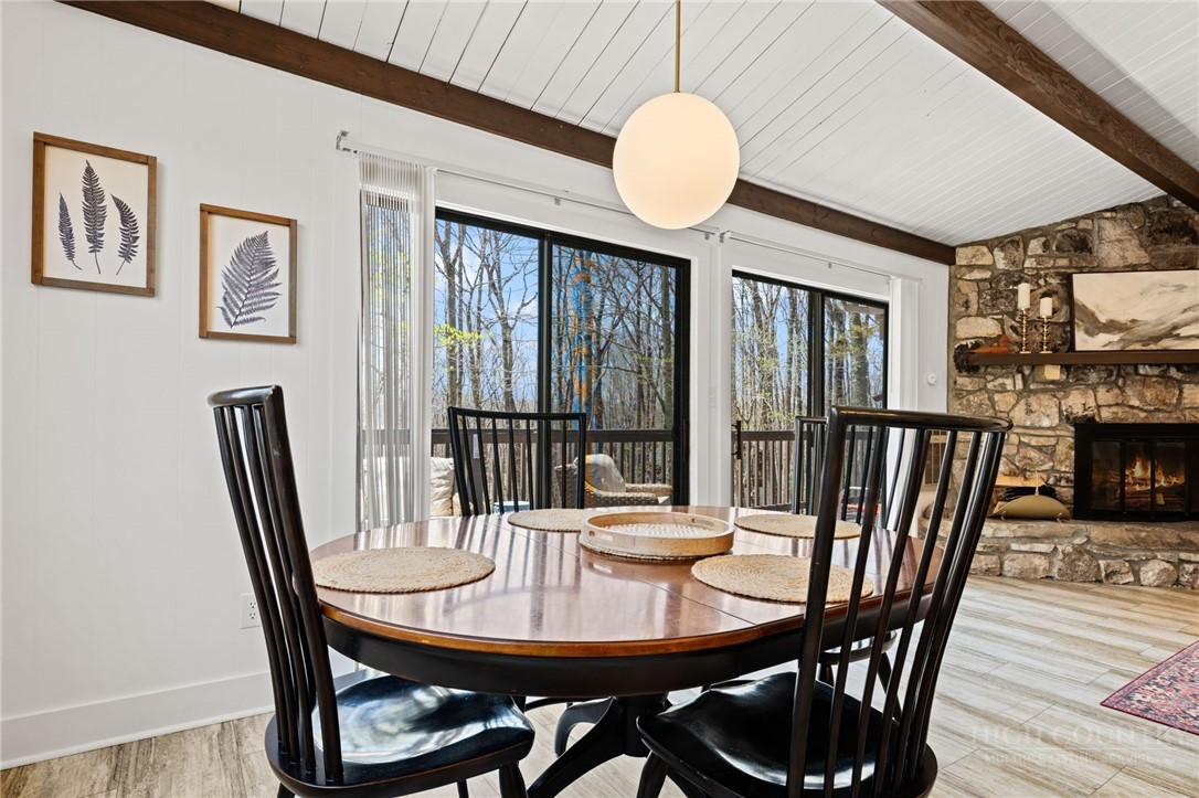 811 Pine Ridge Road Beech Mountain, NC 28604 - Photo 11 of 26 a view of a dining room with furniture window and wooden floor