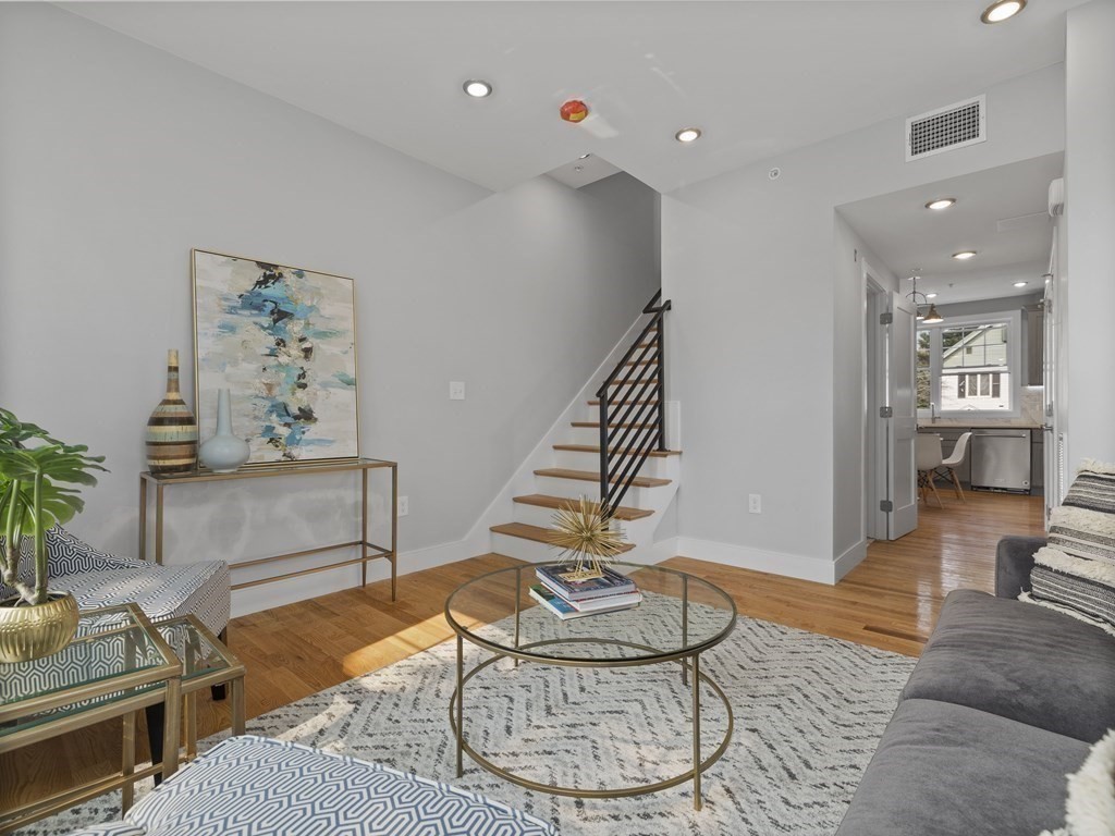 106-116 Main Street Everett, MA 02149 - Photo 12 of 24 a living room with furniture and wooden floor