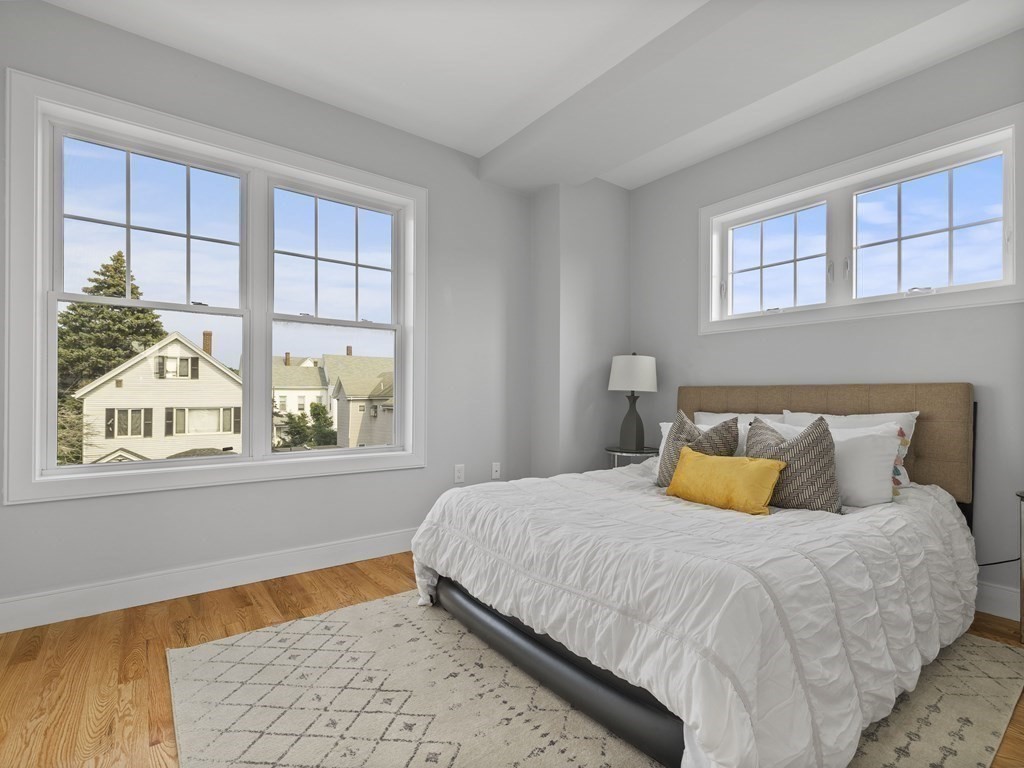106-116 Main Street Everett, MA 02149 - Photo 18 of 24 a bedroom with a bed and window