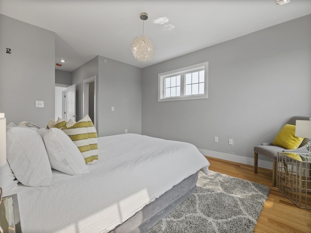 106-116 Main Street Everett, MA 02149 - Photo 21 of 24 a bedroom with a bed and chair