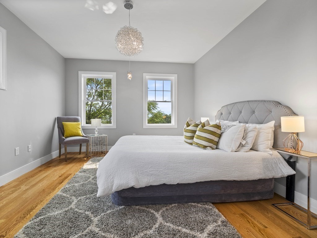 106-116 Main Street Everett, MA 02149 - Photo 22 of 24 a bedroom with a bed a chair and next to a window