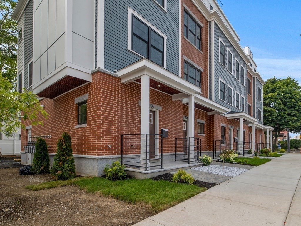 106-116 Main Street Everett, MA 02149 - Photo 3 of 24 a view of a brick building next to a yard