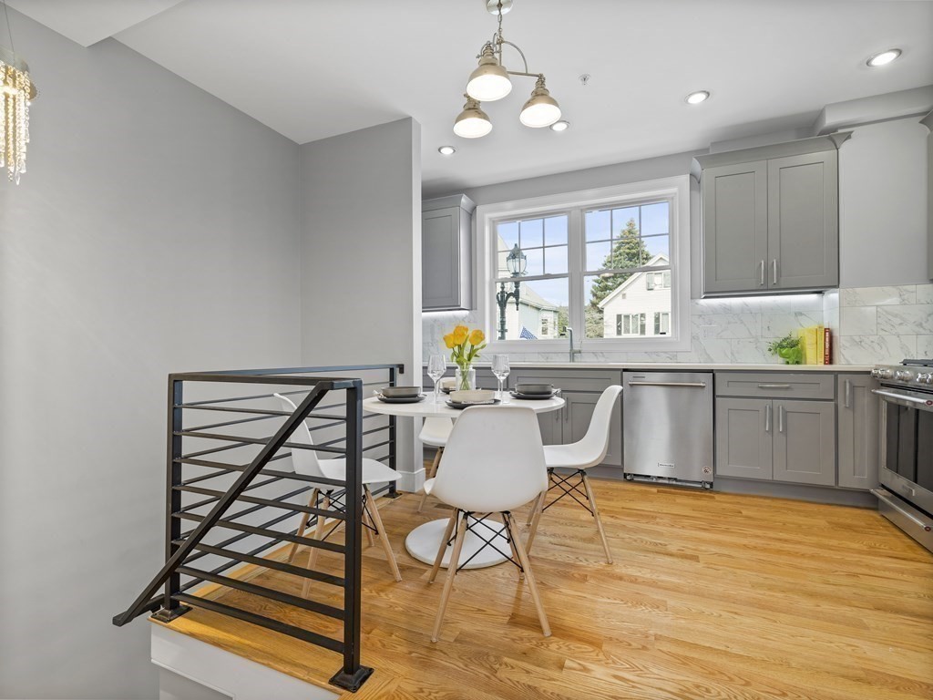 106-116 Main Street Everett, MA 02149 - Photo 6 of 24 a kitchen with a table chairs and wooden floor