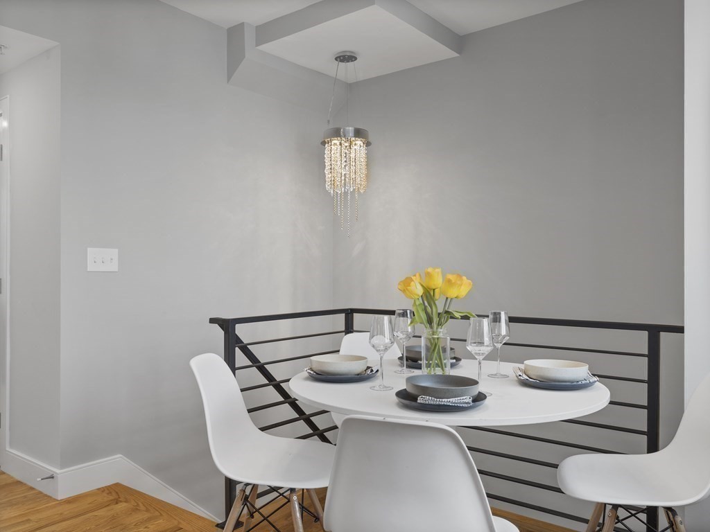 106-116 Main Street Everett, MA 02149 - Photo 9 of 24 a view of a dining room with furniture and wooden floor