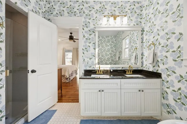 a bathroom with a granite countertop sink and a mirror