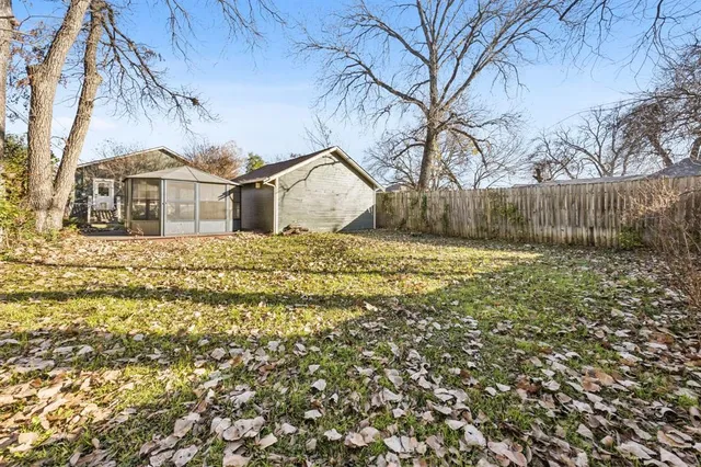 a view of a yard with a house in the background
