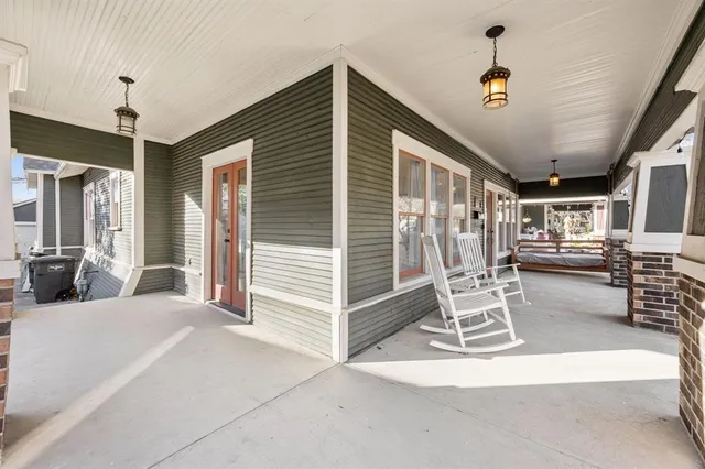 a view of a livingroom with wooden floor and furniture