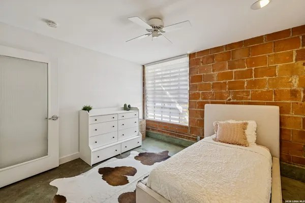 a bedroom with a bed and a dresser