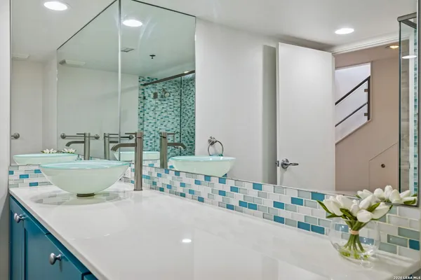 a spacious bathroom with a double vanity sink and a mirror